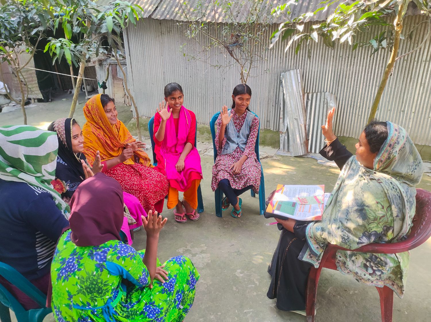 A group of women seated together during a community health education session.